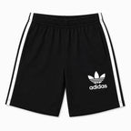 Boy wearing black Adidas summer coord set for boys aged 1 to 12, featuring comfortable fabric and sporty style.