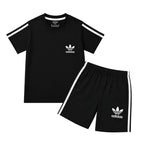 Boy wearing black Adidas summer coordinate set for boys aged 1 to 12, featuring a comfortable matching top and shorts.