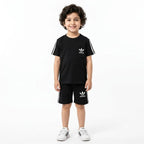 Boy wearing black Adidas summer coord set for boys aged 1-12, featuring a matching top and shorts from Lil Cubs.