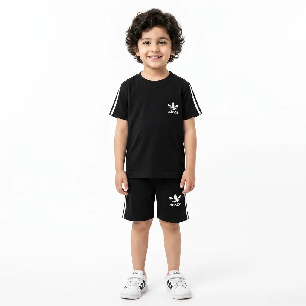 Boy wearing black Adidas summer coord set for boys aged 1-12, featuring a matching top and shorts from Lil Cubs.