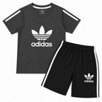 Boys in grey and black Adidas summer coordinate set, 2-piece outfit for ages 1-12, featuring comfortable fabric and sporty style.