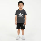 Young boy wearing a grey and black Adidas summer coordinate set for boys aged 1 to 12, featuring a top and shorts, by Lil' Cubs.
