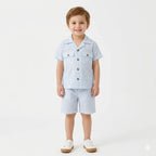 Boy wearing Lil' Cubs blue check cotton summer coord set, consisting of a short-sleeve shirt and shorts for ages 6 months to 5 years.