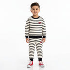 Young boy wearing white Levi's winter coordinate set with jacket and pants, size 1-12 years, by Lil' Cubs, outdoors.