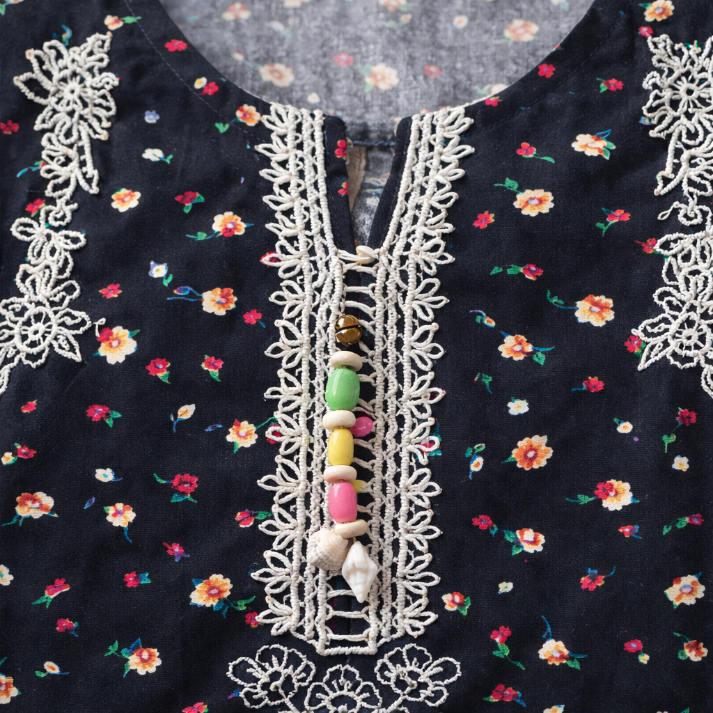Girls black floral cotton shalwar kameez with traditional design, featuring a black kameez with colorful floral patterns and matching shalwar.