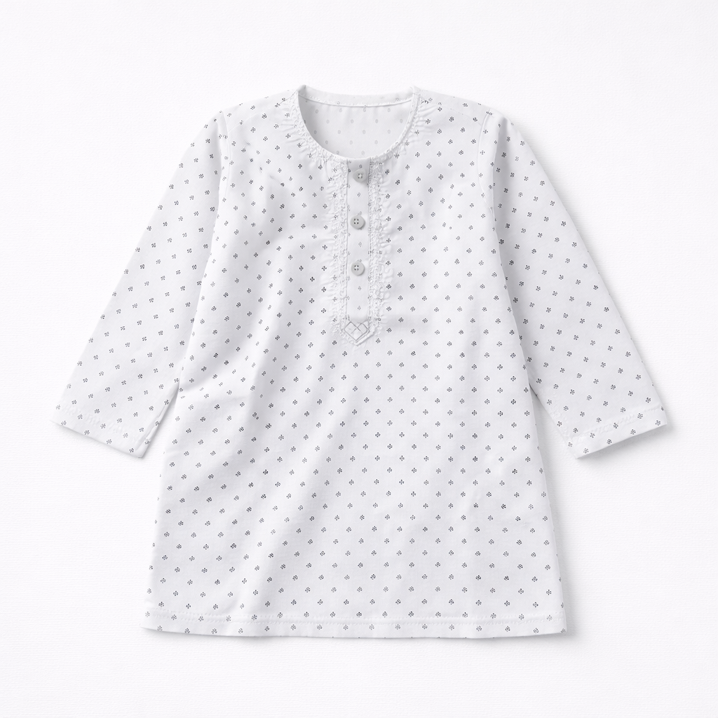 Boy wearing white cotton shalwar kameez, traditional Pakistani outfit for boys, in a comfortable and stylish design.