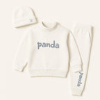 Cream white 3-piece rib fabric kids outfit set with sweatshirt, jogger pants, and beanie hat for toddlers aged 6 months to 5 years, featuring panda print.

