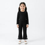 Girls black ribbed trousers by Lil' Cubs for ages 3 to 12 years, featuring a comfortable fit and imported fabric.