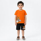 Boy wearing an orange tiger-themed summer coord set by lilcubspk, featuring a short-sleeve top and shorts for ages 1-12.