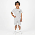 White boys' summer polo coord set by Lil Curbspk, featuring a white polo shirt and matching shorts for ages 12 months to 10 years.