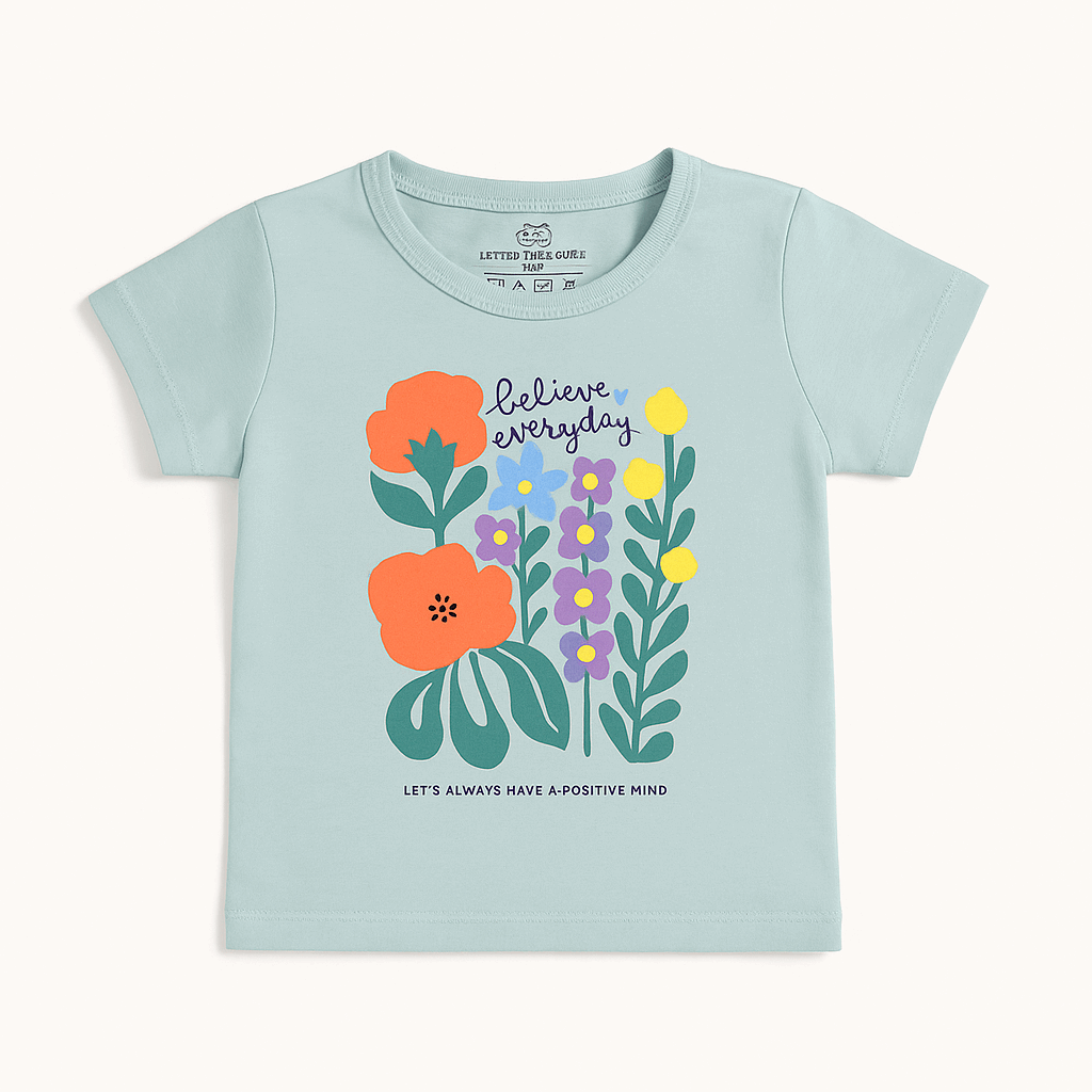 Girls sage green cotton t-shirt with believe everyday floral print – casual summer wear for ages 1 to 12 – flat lay
